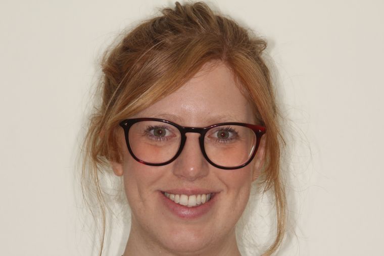 Portrait of a girl wearing glasses and smiling with her new smile.